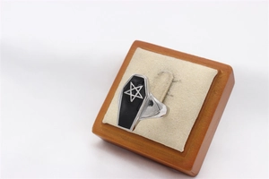 Macro shot of gothic vintage star ring on a wooden display stand with fabric