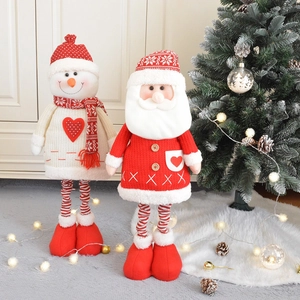 Standing telescopic Christmas plush dolls with Santa and Snowman in a cozy home setting