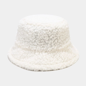 Close-up of thick white faux lamb wool bucket hat showing soft fleece texture