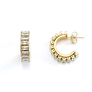 Macro detail of gold C-shaped earrings featuring rectangular cubic zirconia inlays