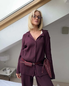 Detail of pleated knit texture on wine red polo long sleeve and matching trousers