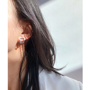 Minimalist silver geometric square hoop earrings shown on a model in a side view