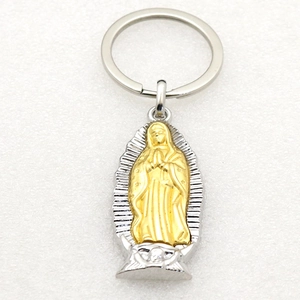 Polished silver and gold Our Lady of Guadalupe metal pendant keychain on white background