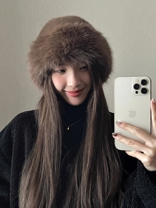 Detail of soft brown faux fur winter bucket hat showing its fluffy texture and warmth