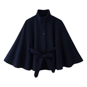 Detail view of navy blue wool cape coat with stand-up collar and large bow waist belt