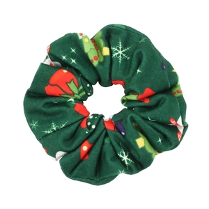 Detail of forest green Christmas scrunchie with festive tree and snowflake prints