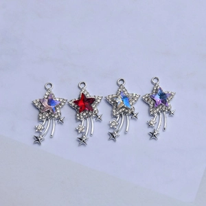 Detail of star-shaped DIY pendants with colorful crystals and sparkling zircon meteor trails