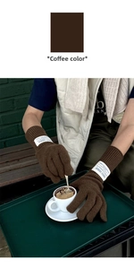 Close-up of coffee brown knitted wool gloves with vintage label and ribbed texture