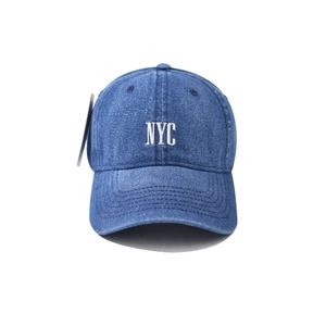 Detail view of washed denim baseball cap with white NYC embroidery and premium stitching