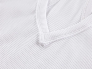 Detailed close-up of white ribbed knit fabric texture and V-neck stitching on the tank top