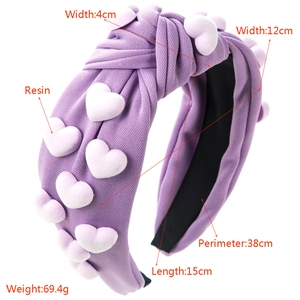 Purple knotted wide headband with heart resin accents and textured fabric finish