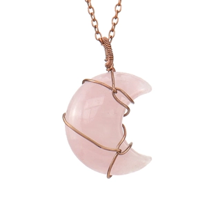 Macro detail of handmade copper wire-wrapped rose quartz moon pendant necklace
