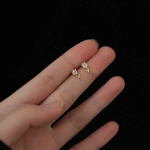 Detailed view of tulip stud earrings featuring gold finish and sparkling drop-shaped zircon