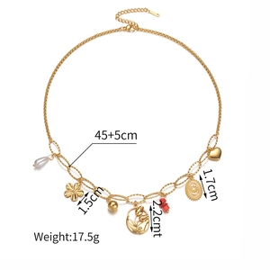 Detail showing multi-pendant gold necklace with pearl, flower, and heart charms