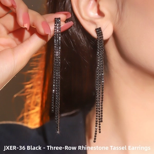 Detailed macro view of long black rhinestone fringe earrings on an elegant model