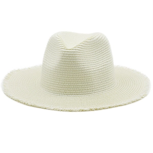 Detailed close-up of cream raffia fedora hat with natural frayed fringe brim design