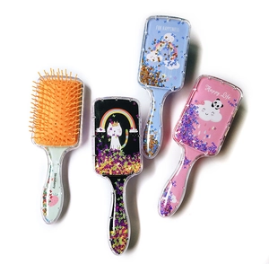 Detail of four colorful liquid glitter hair brushes with cartoon patterns and sequins