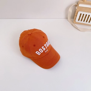Close-up of orange cotton baseball cap featuring white BOSTON 1630 embroidery detail