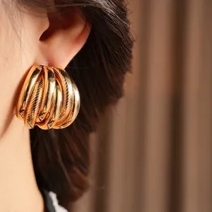 Chunky layered gold earrings with a minimalist multi-ring design for a luxury fashion look