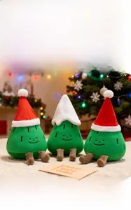 Close-up of cute plush Christmas tree dolls with festive hats and embroidery detail