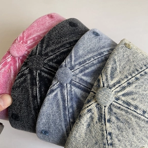 Detail of distressed washed denim baseball caps in four colors with stitched eyelets