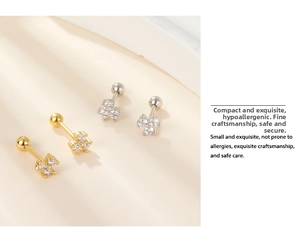 Close-up of gold and silver cluster stud earrings with zircon and ball screw backs