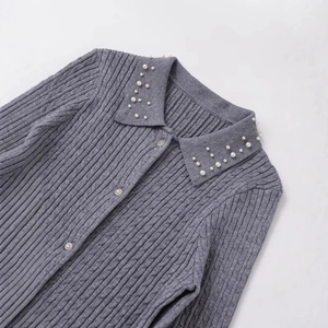 Light gray cable knit sweater featuring a stylish pearl embellished collar and buttons