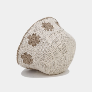 Detail of hand-crocheted bucket hat with beige cotton yarn and brown floral patterns