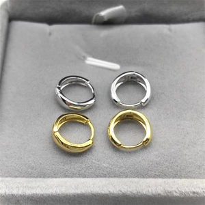 Polished S925 sterling silver and gold hoop earrings on a grey velvet display tray