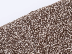 Macro detail of brown and white blended knit wool fabric texture with high quality finish