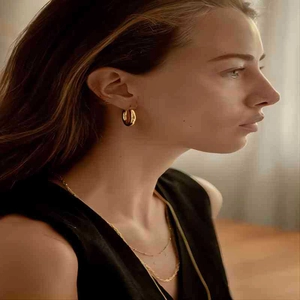 Chic 18k gold plated hollow hoop earrings and necklace set worn by a model in warm light