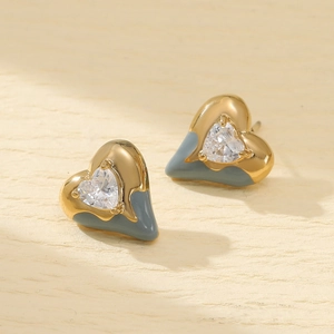 Macro detail of heart earrings with grey enamel inlay and sparkling zircon in 18K gold plating