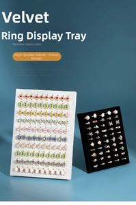 Velvet picture frame style ring display stands in grey and black on a blue backdrop