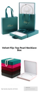 Macro view of velvet jewelry gift boxes with pearl necklace and matching paper bags