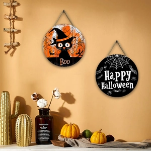 Set of two round Halloween wooden signs with black cat and spider web on a beige wall