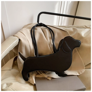 Macro detail of a black dachshund-shaped leather shoulder bag against a beige blazer background