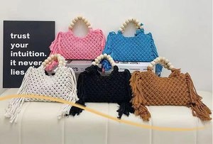 Detailed view of handmade macrame bags with long tassels and wooden beaded handles