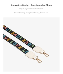 Detail of colorful LOVE embroidery on black shoulder strap with gold metal clasp