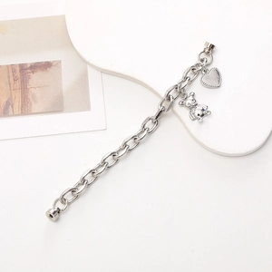 Silver dual-chain bracelet with heart and bear charms featuring magnetic clasps