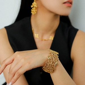 18k gold plated vintage hollow flower open bracelet jewelry set on female model
