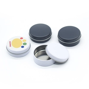 Top view of small black and white round metal tins showing interior and GAEGUMUNG print