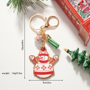 Christmas snowman wooden keychain with tassel and star charm in holiday setting