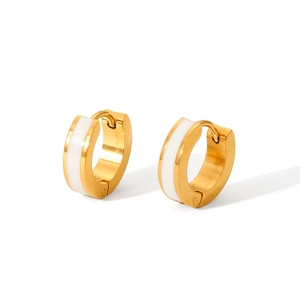 Macro detail of gold-plated hoop earrings with white enamel inlay and secure hinge