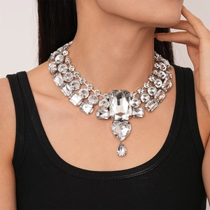 Close-up of luxury silver-tone choker with mixed-cut crystals and heart pendant on model