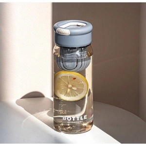 Close-up of portable plastic tea bottle with built-in filter and lemon slice inside