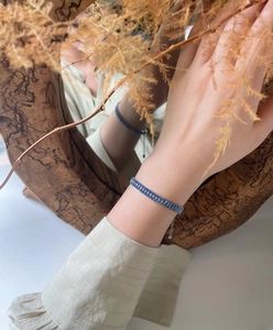 Detail showing mermaid blue triple-row crystal bracelet with adjustable chain on wrist