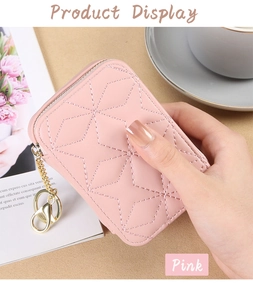 Detailed view of a pink quilted mini bag with gold chain strap in a lifestyle setting