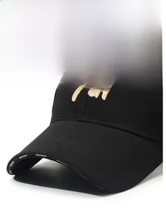 Detail of black baseball cap with golden embroidery and logoed inner sweatband