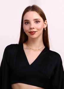 Model wearing 18K gold plated necklace and earrings set with delicate flower charms