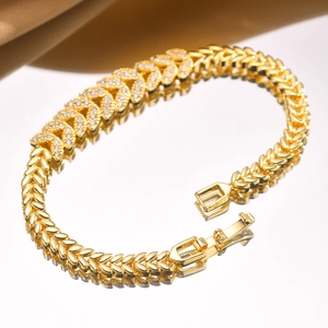 Detail of gold zircon bracelet with leaf-shaped links and secure folding clasp
